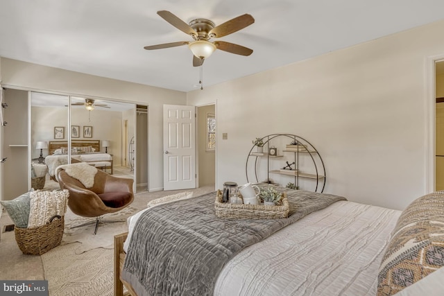 carpeted bedroom featuring ceiling fan and a closet