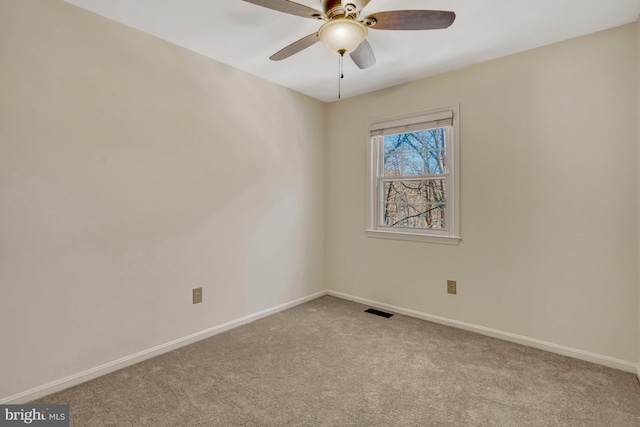 carpeted spare room with ceiling fan