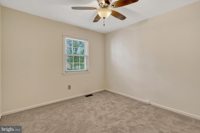 unfurnished room featuring ceiling fan and light carpet