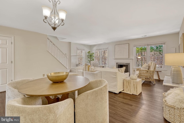 dining room featuring an inviting chandelier and dark wood-type flooring