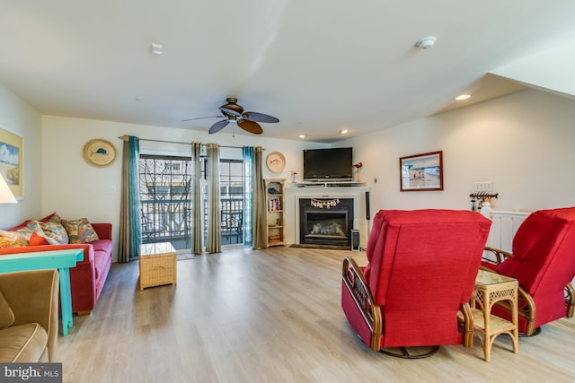 living room featuring ceiling fan and light hardwood / wood-style floors