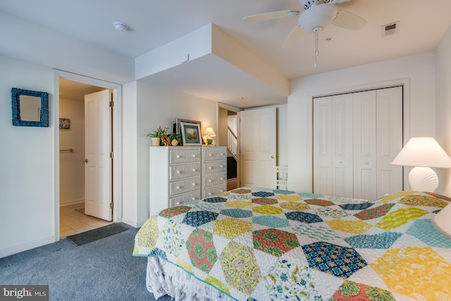 carpeted bedroom featuring a closet and ceiling fan