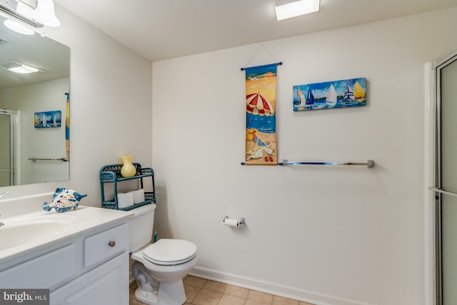 bathroom with toilet, tile patterned flooring, walk in shower, and vanity