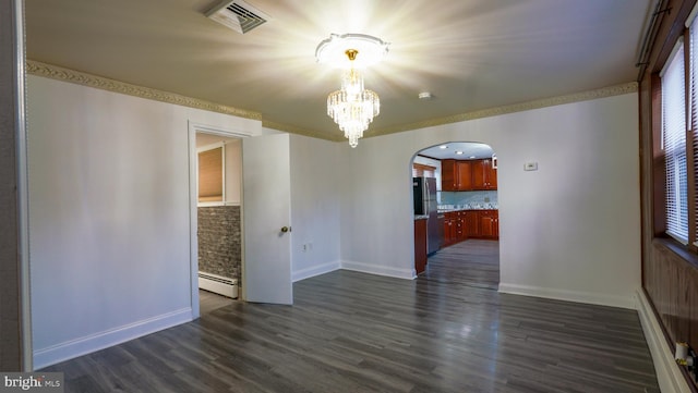 unfurnished room with dark wood-type flooring, a chandelier, and a baseboard heating unit