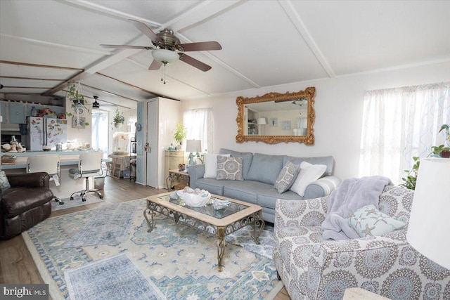 living room featuring ceiling fan, vaulted ceiling, and hardwood / wood-style flooring