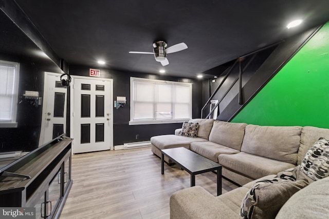 living room featuring ceiling fan, light wood-type flooring, and a baseboard radiator