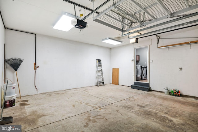 garage featuring separate washer and dryer and a garage door opener