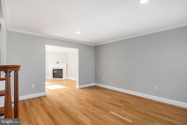 unfurnished living room with ornamental molding and light hardwood / wood-style flooring