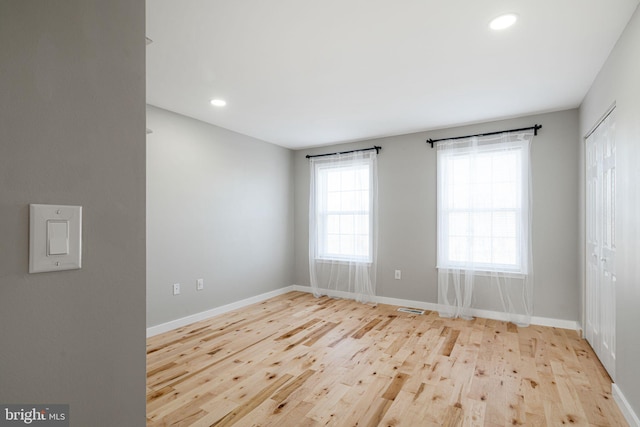 unfurnished room with light hardwood / wood-style flooring