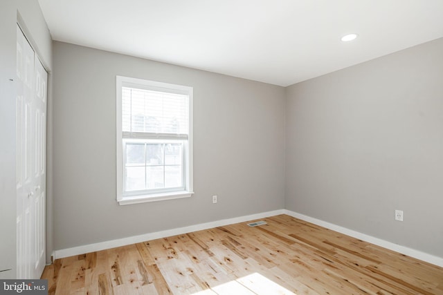 unfurnished room with wood-type flooring