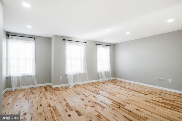 spare room featuring light hardwood / wood-style flooring