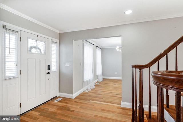 entrance foyer with light wood-type flooring and crown molding