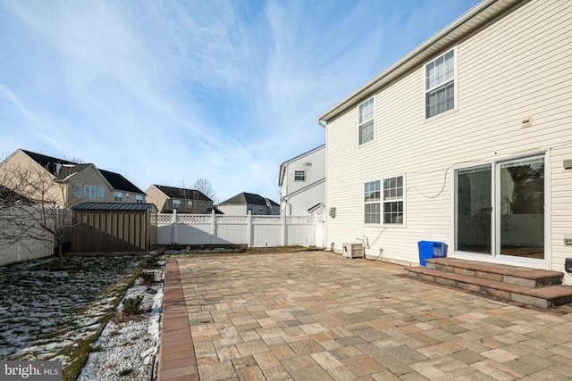 view of patio featuring a storage shed