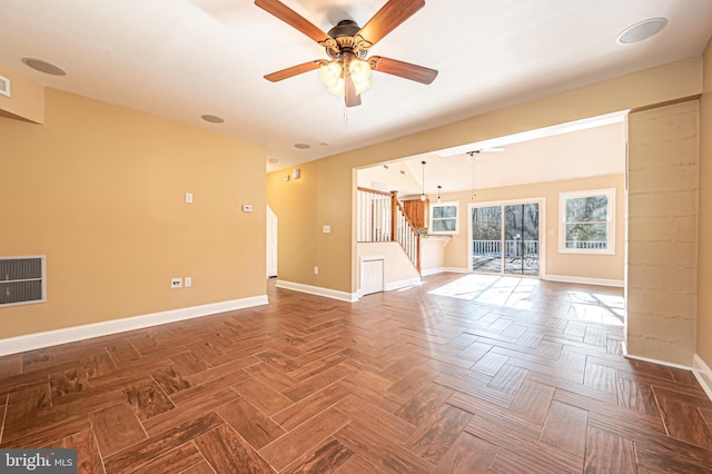 unfurnished living room with ceiling fan and parquet flooring