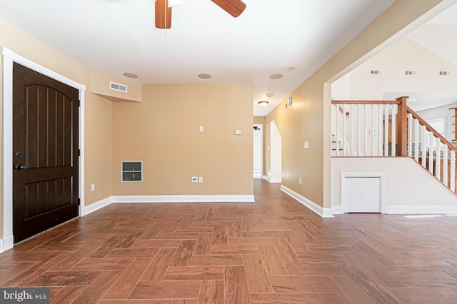 foyer entrance featuring ceiling fan and parquet floors