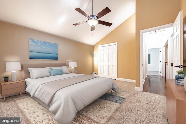 bedroom featuring high vaulted ceiling, ceiling fan, and a closet