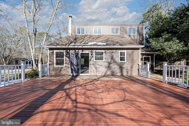 wooden terrace featuring a storage unit