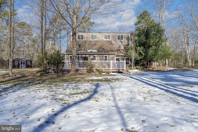 view of front of house with a storage unit and a deck