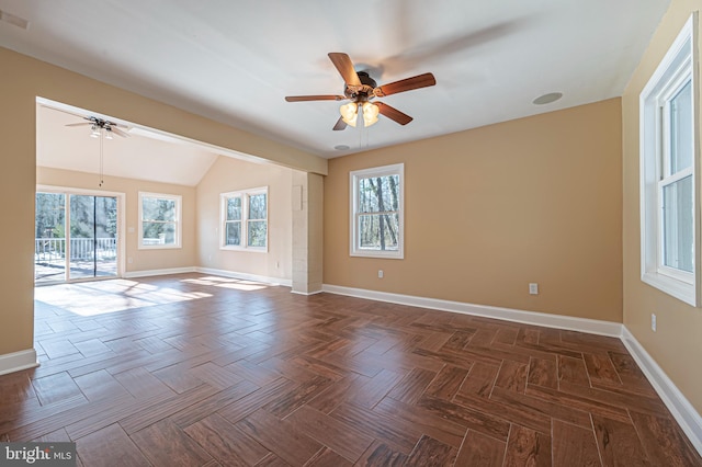 unfurnished room with lofted ceiling, ceiling fan, and dark parquet floors