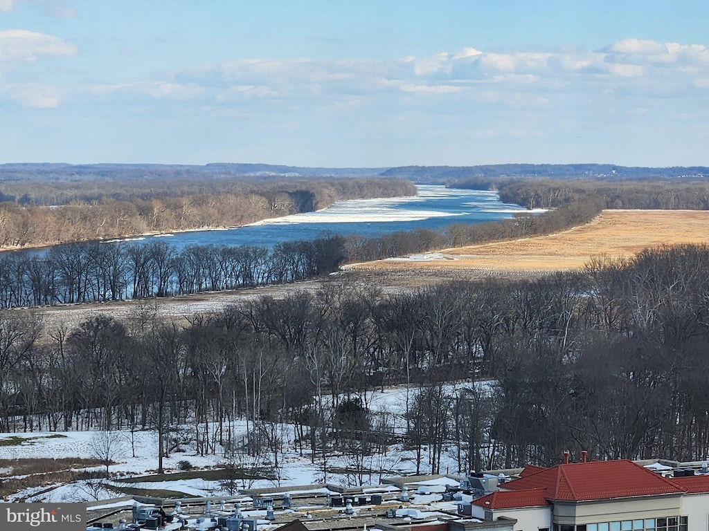 snowy aerial view featuring a water view