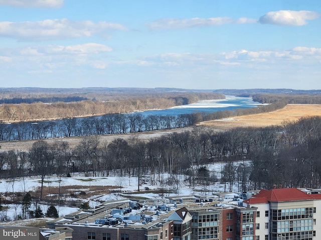 snowy aerial view featuring a water view