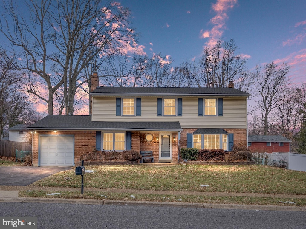 view of front of property featuring a garage and a yard