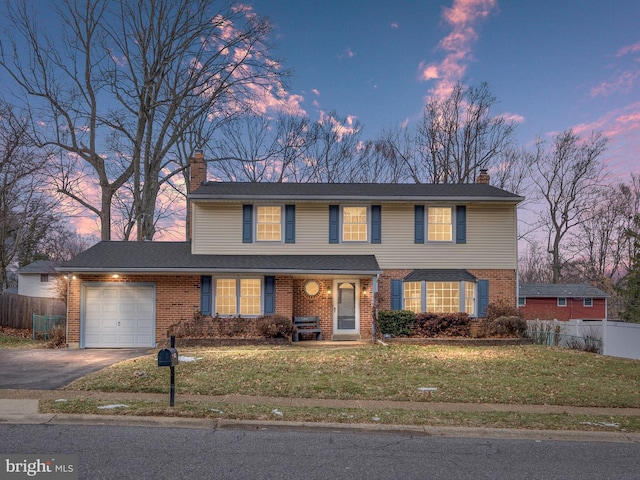 view of front of property featuring a garage and a yard