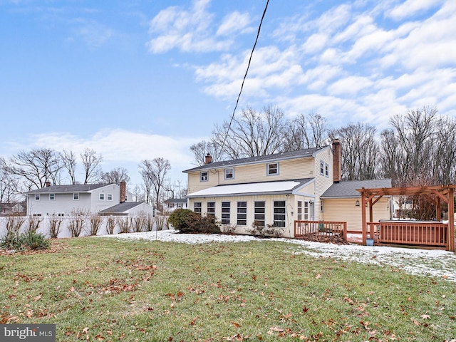 rear view of house with a lawn, a pergola, and a wooden deck