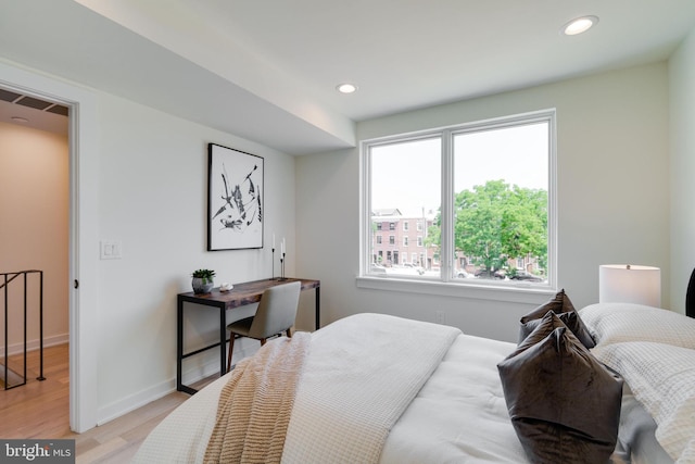 bedroom featuring multiple windows and light hardwood / wood-style floors