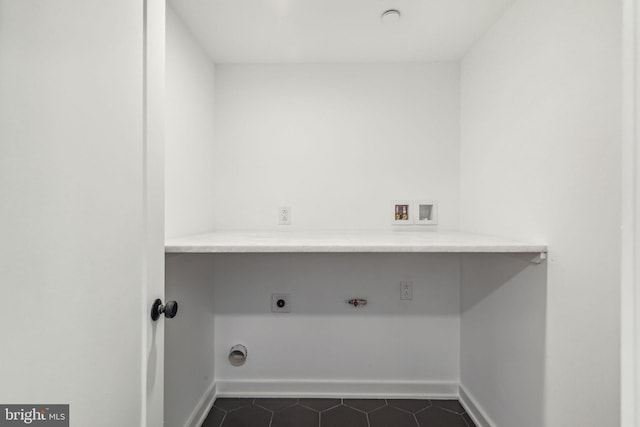 laundry room featuring hookup for an electric dryer, washer hookup, and dark tile patterned floors