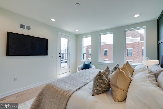 bedroom featuring access to exterior and light wood-type flooring