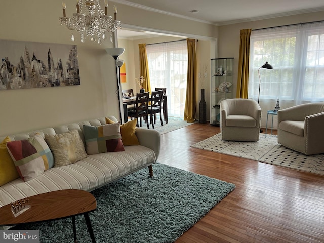 8107 Orville St, Alexandria, VA 22309 - living area featuring hardwood / wood-style flooring, an inviting chandelier, crown molding, and plenty of natural light
