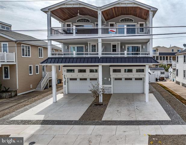 view of front of property with a balcony and a garage