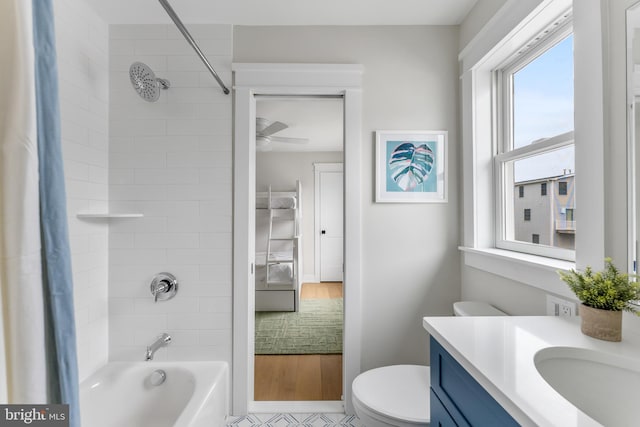 full bathroom featuring toilet, vanity, and tiled shower / bath