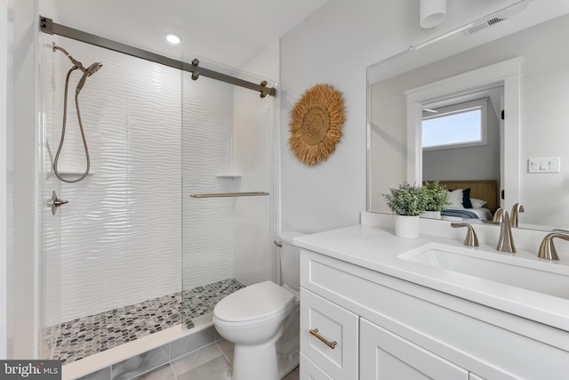 bathroom with toilet, a shower with door, vanity, and tile patterned floors