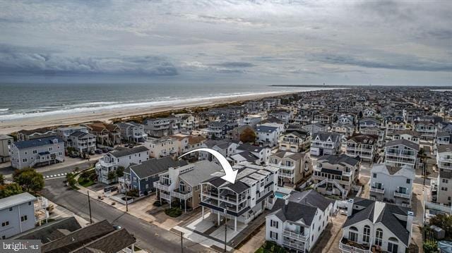 bird's eye view with a water view and a view of the beach