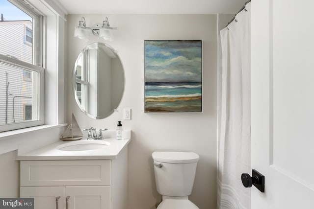 bathroom featuring toilet and vanity