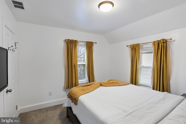 bedroom with vaulted ceiling and carpet