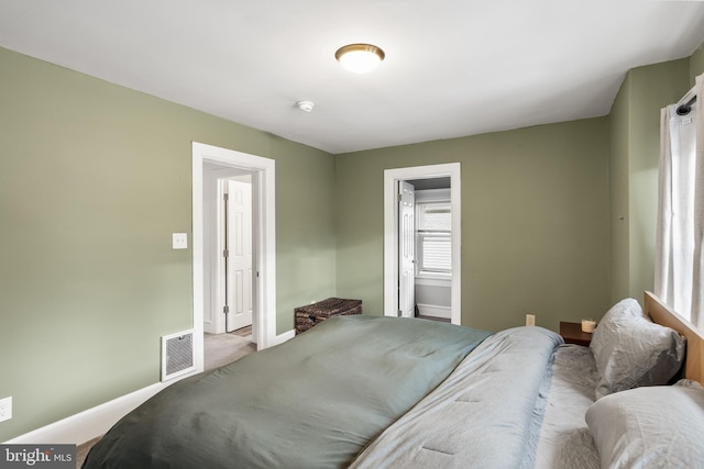 bedroom featuring ensuite bath