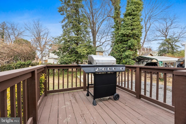 wooden terrace featuring a grill