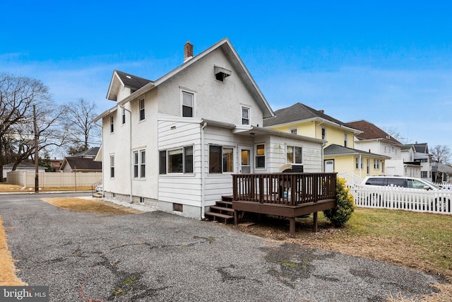 back of property featuring a deck