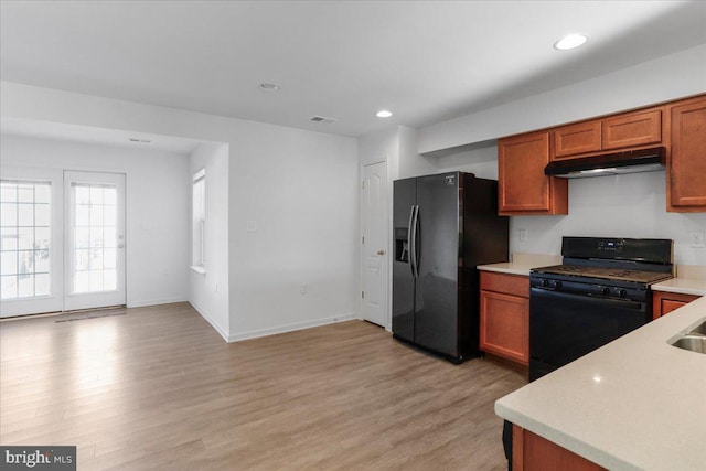 kitchen featuring black appliances and light hardwood / wood-style flooring