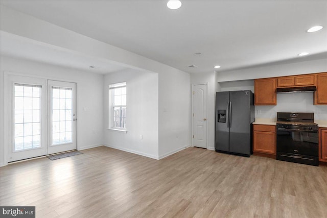 kitchen with light wood-type flooring and black appliances