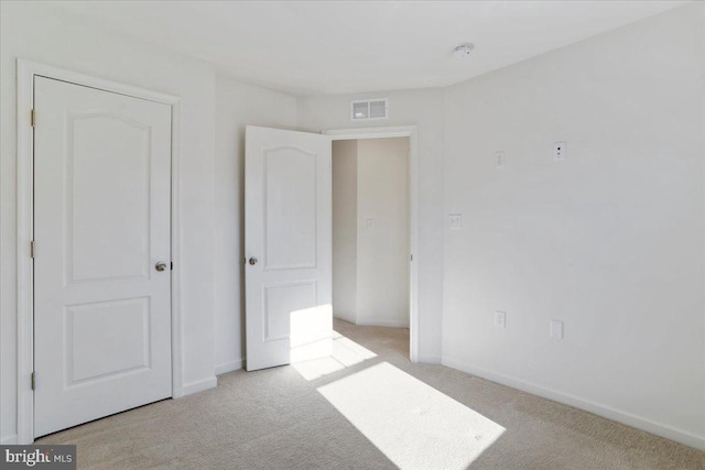 unfurnished bedroom with light colored carpet