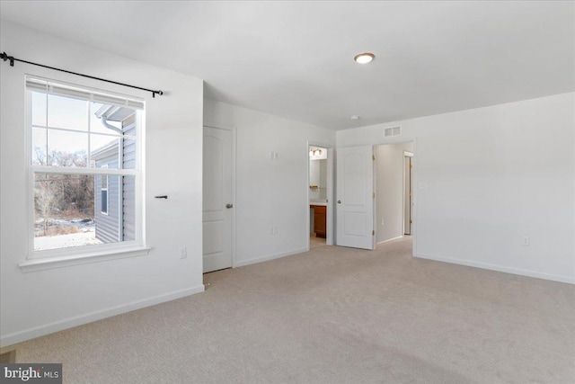 empty room featuring light colored carpet