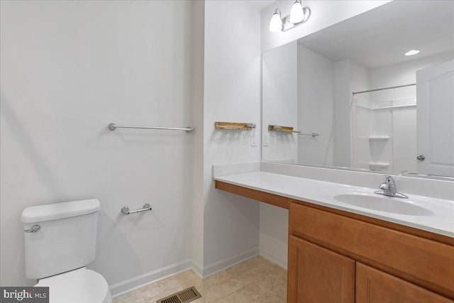 bathroom with toilet, vanity, and a shower