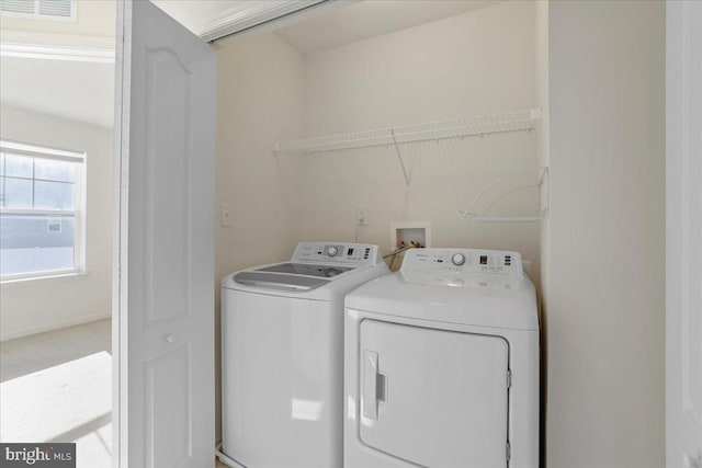 laundry area with separate washer and dryer and carpet floors