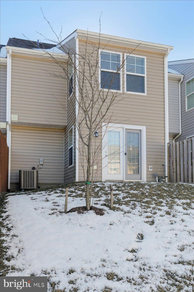 snow covered property featuring central air condition unit