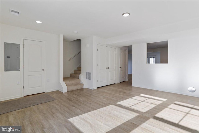 interior space featuring light wood-type flooring and electric panel