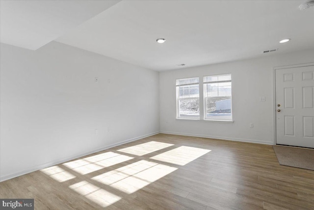 unfurnished room with light wood-type flooring